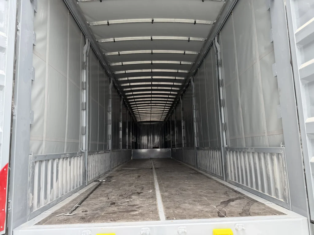 Interior of a 5 axle curtain side trailer with lower sideboards and horizontal rails