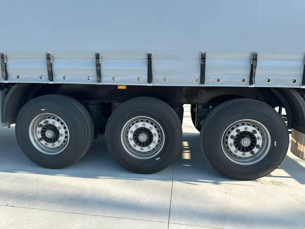 Three rear axles below the cargo body of the curtain side semi trailer